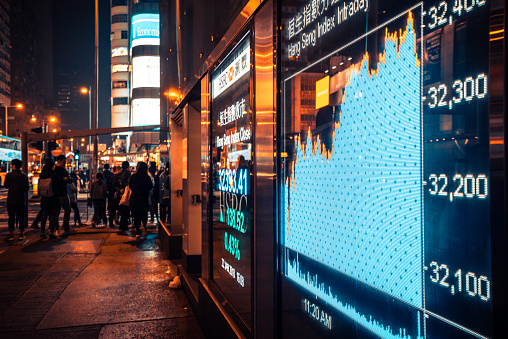 financial display board in Mong Kok, Hong Kong, China
Pedestrians walking and waiting in the background