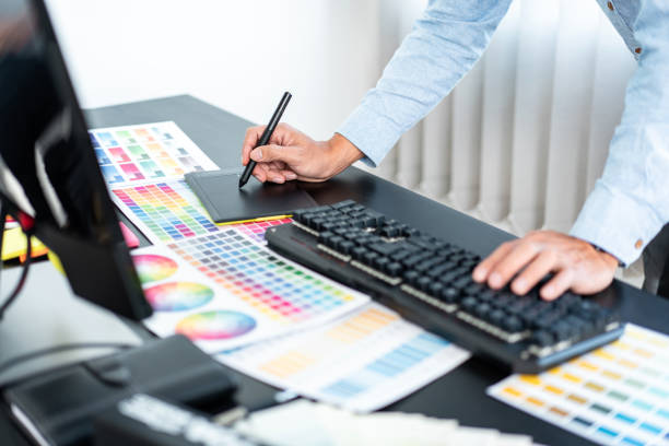 istock Young creative graphic designer working on color selection and drawing on graphics tablet at workplace, Color swatch samples chart for selection coloring in inspiration to create new collection 1405477761