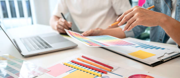 istock Two creative graphic designer team working on color selection and drawing on graphic tablet, Color swatch samples chart for selection coloring in inspiration to creativity at workplace 1405477899