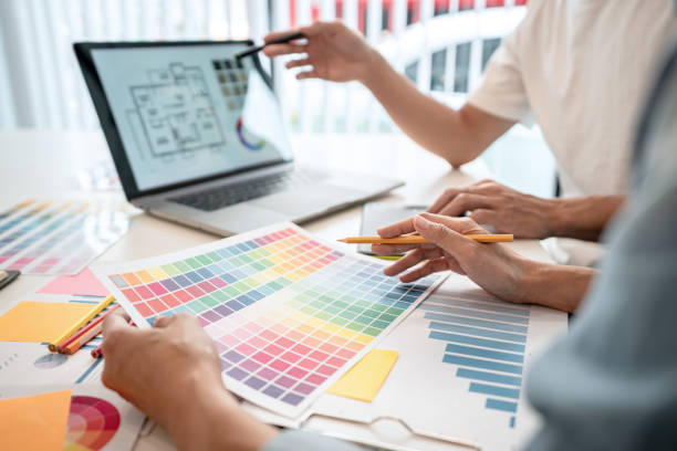 istock Two creative graphic designer team working on color selection and drawing on graphic tablet, Color swatch samples chart for selection coloring in inspiration to creativity at workplace 1405477920