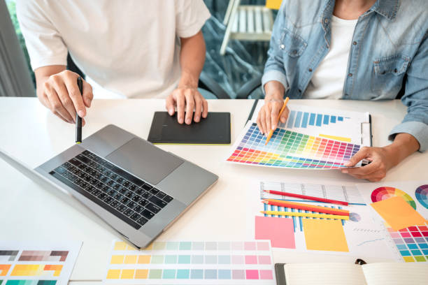 istock Team of creative graphic designer working on color swatch samples chart for selection coloring in inspiration to create new collection at workplace 1405477928