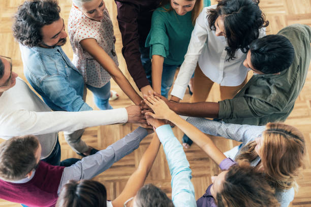 Successful teamwork Shot of business people stacking their hands on top of each other, in circle hands clasped stock pictures, royalty-free photos & images