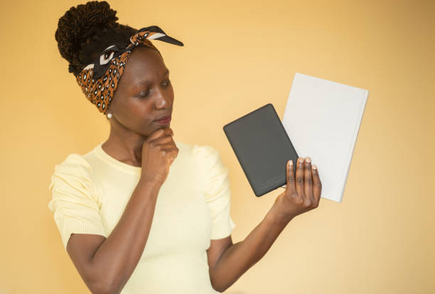 istock Young woman debating between printed book or ebook 1405479666