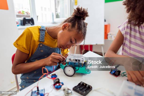 Focused Girl On Stem Class Making Robots Stock Photo - Download Image Now - Robotics, STEM - Topic, High School