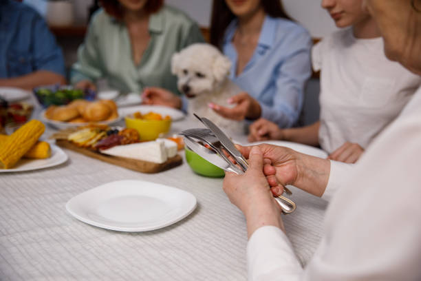 istock Senior woman sorting out cutlery and setting up the table for dinner 1405486065