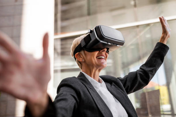 istock Mature woman using VR glasses 1405486487