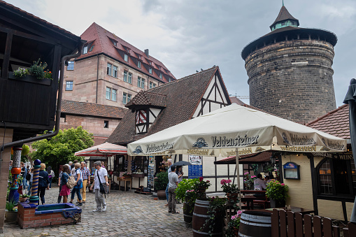 Nuremberg, Germany - July 2, 2016: Medieval shopping area with small shops focusing on traditional crafts, plus rustic restaurants.