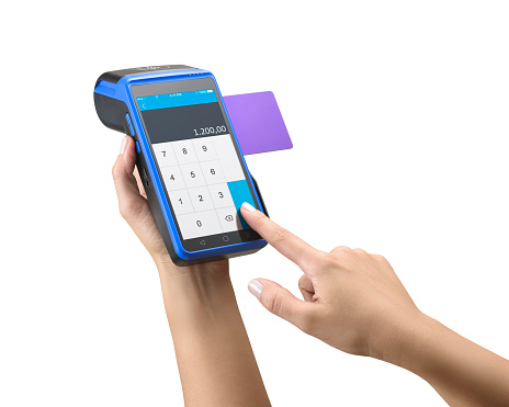 Three quarter view of caucasian hand holding a contactless credit and debit card machine, isolated on white