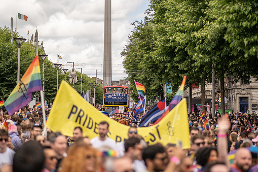 Crowds of people marching in the Dublin Pride parade 2022,  on O'Connell Street, with selective focus