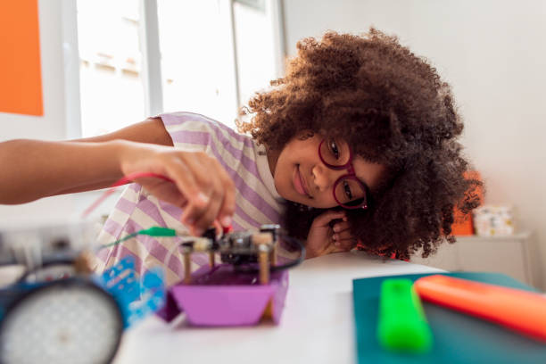 istock Brazilian girl  programming robot for a school competition 1405492182