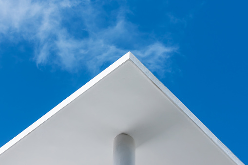 Abstract architecture background with white concrete corner and pillar under blue sky