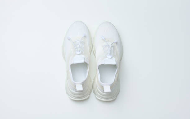 istock White textile sneakers on a white background, top view 1405493897