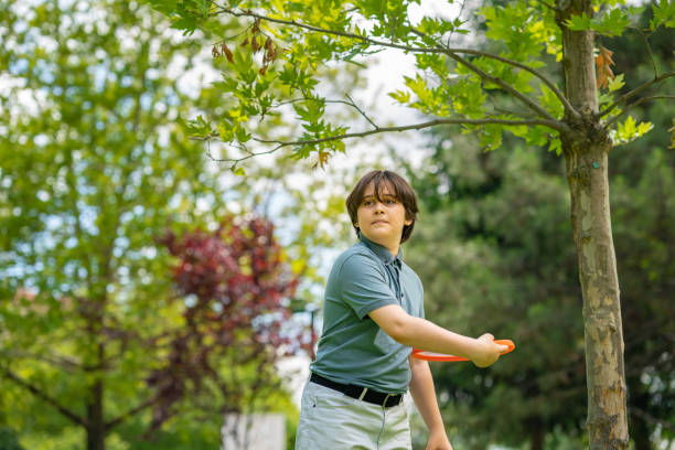 istock 11 years old boy playing games  in nature 1405494143
