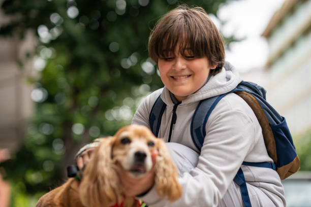 istock 11 years old boy playing with the dog 1405494312