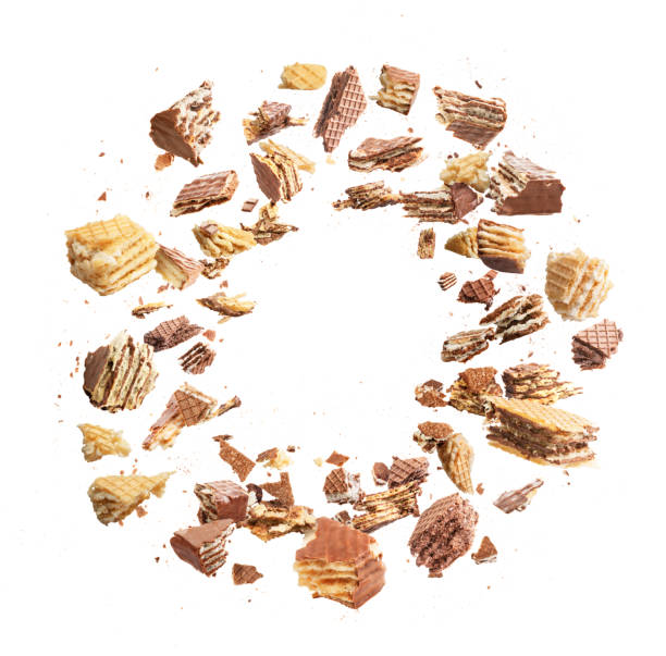 istock Wafers are broken into pieces, with a chocolate splash isolated on a white background 1405495451