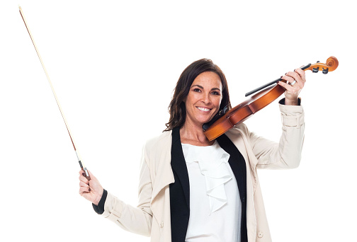 Portrait of aged 40-44 years old who is beautiful with long hair caucasian young women violinist standing in front of white background wearing businesswear who is happy and holding violin