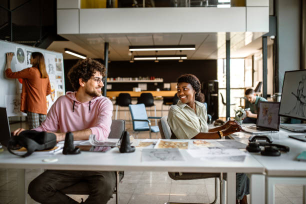 istock Team of illustrators working in the office on a new mobile app 1405498504