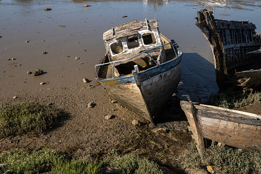 set of wrecks of old abandoned boats, cemetery of boats stranded on the shore in Brittany