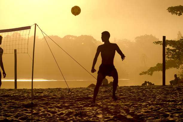 Boy playing futvolley on the beach. Camburi Beach, São Sebastião - State of São Paulo, Brazil. June 23, 2022.