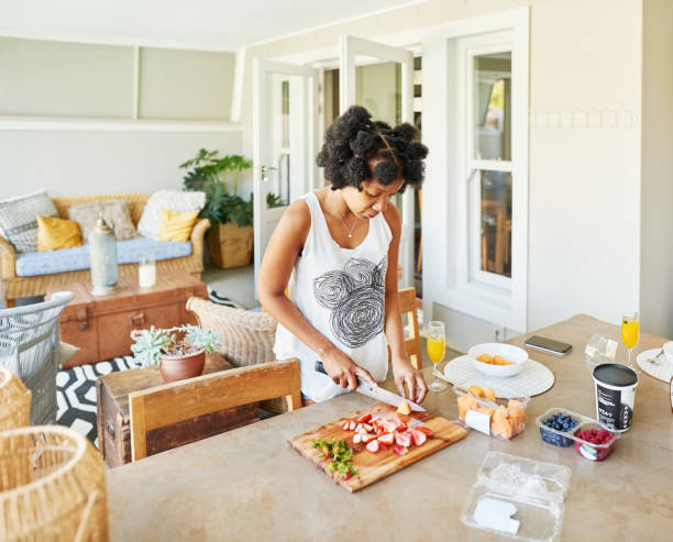 istock African woman preparing breakfast in kitchen at home 1405509246