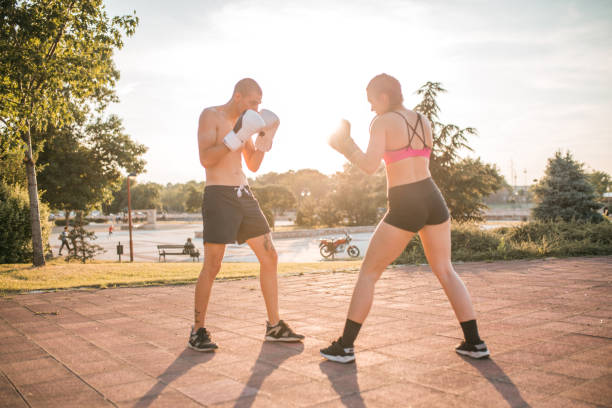 istock Couple in love is training boxing in the park 1405516621