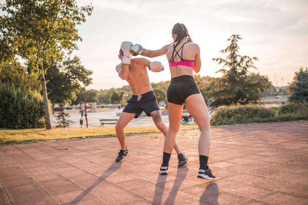 istock Two young fighters train kickboxing together, during a sunny day 1405518951