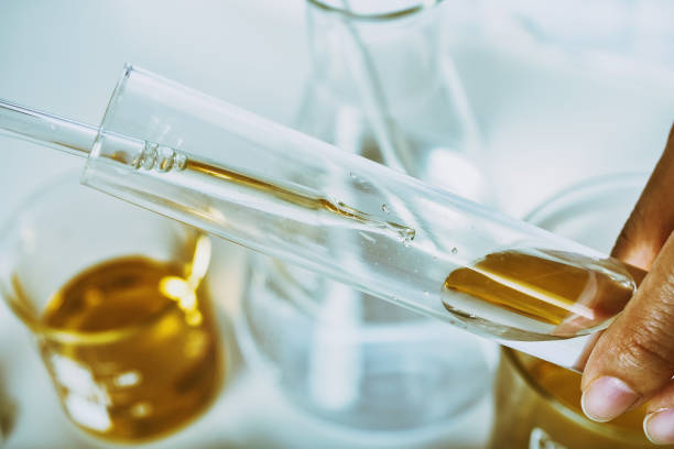 istock Oil dropping, Chemical reagent mixing, Laboratory and science experiments, Formulating the chemical for medical research, Quality control of petroleum industry products concept. 1405519886