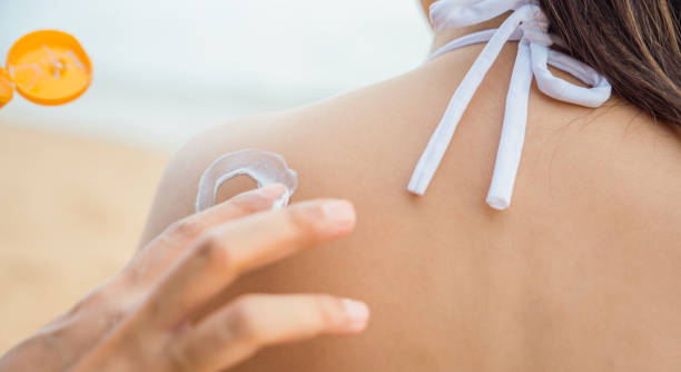 istock young man applying suntan lotion with sun shape on girlfriend back shoulder 1405520217