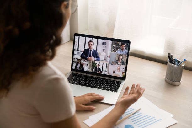 istock Woman sit at desk at home participate in business videoconference 1405521731