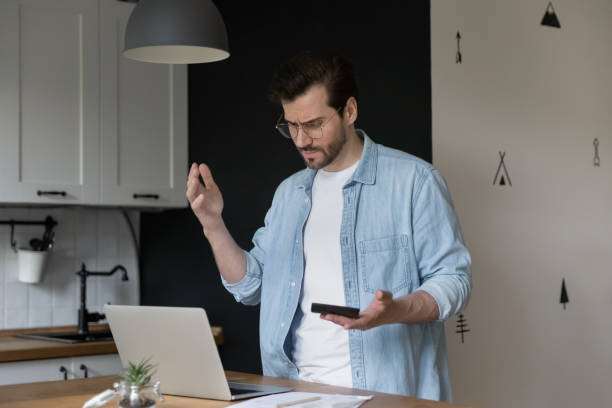 istock Man calculating personal finances feels stressed about financial problems 1405522712