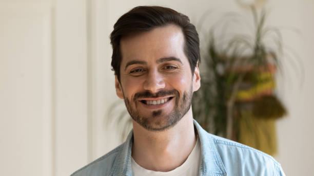 istock Headshot portrait of millennial guy posing smiling on camera 1405522749