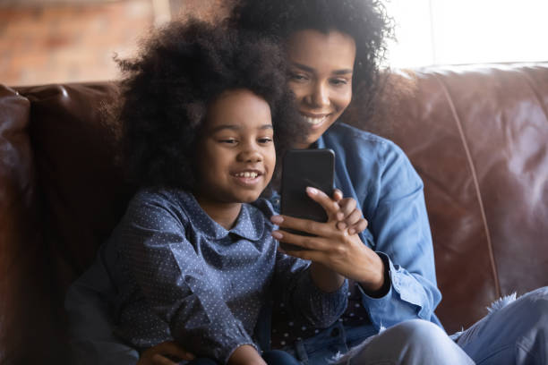 istock Happy bonding African American family using cellphone. 1405522797