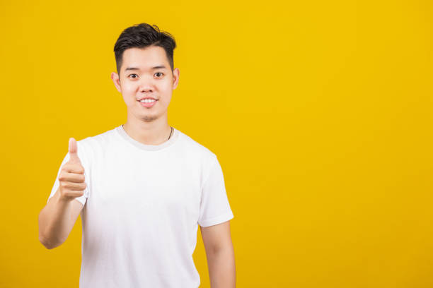 istock man smiling positive showing thumbs up gesture 1405522839