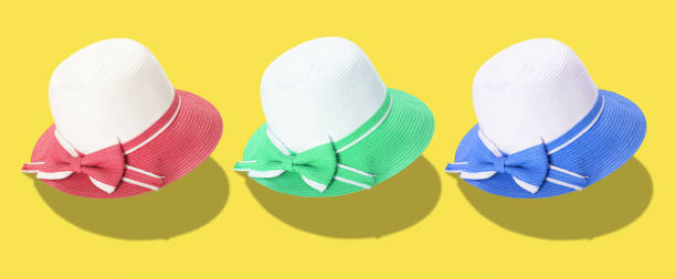 istock Pretty straw hat with ribbon and bow on white background. Beach hat top view isolated 1405523033