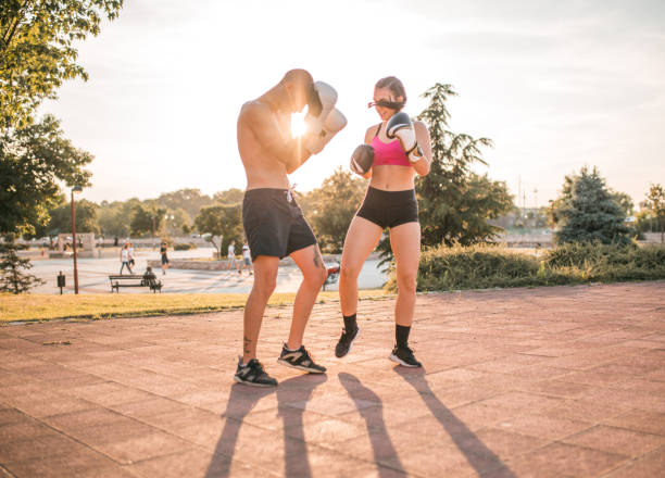 istock Two strong young people are training boxing in the park 1405523039