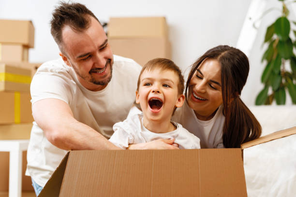 istock Parents and son packing boxes and moving into a new home 1405523042