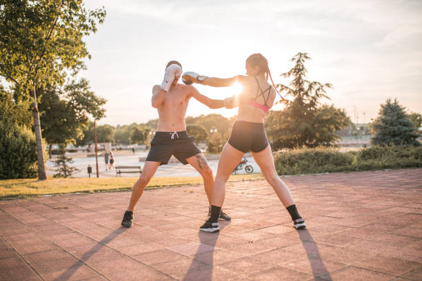 istock Two athletes train kickboxing together in the park 1405524990