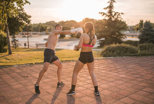 istock Two fighters train kickboxing together in the park 1405525658