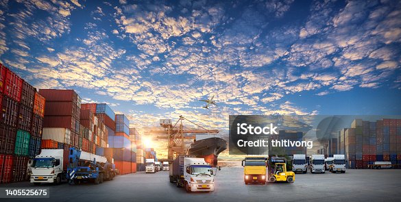 istock Container truck in ship port for business Logistics and transportation of Container Cargo ship and Cargo plane with working crane bridge in shipyard at sunrise, logistic import export and transport industry background 1405525675