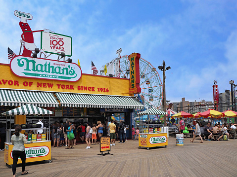 New York, NY - July 11, 2017:  Coney Island amusement area in New York with Nathan's Famous hot dog stand