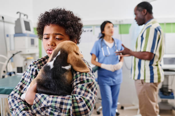 istock Kid Comforting Pup After Vaccination 1405525719