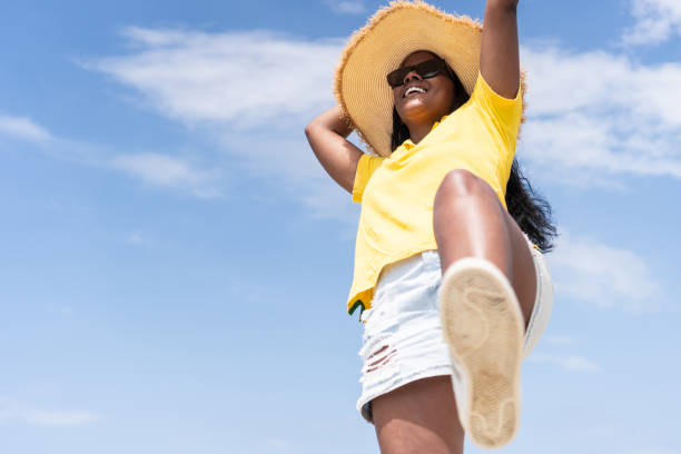 istock Optimistic Female Walking Against Blue Sky 1405529213