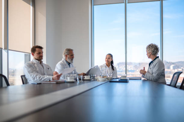 istock Proficient Doctors Discussing at Table in Board Room 1405531131