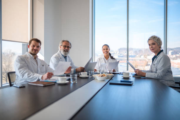 istock Diverse Group of Medical Specialists at Table Looking at Camera 1405531137
