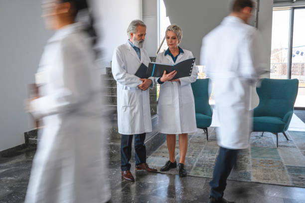 istock Busy Hospital With Two Senior Doctors Having a Discussion 1405531346