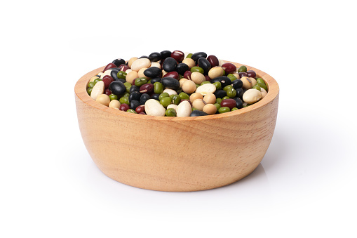 Mix beans in wooden bowl isolated on white background.