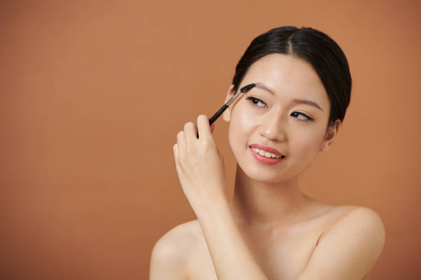 istock Woman Brushing up Eyebrows 1405533117