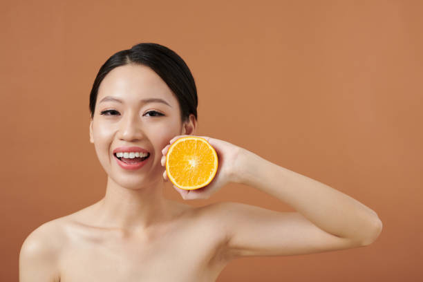 istock Happy Young Woman Holding Orange 1405533149
