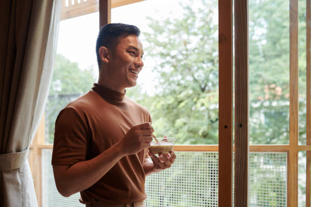 istock Smiling Man Eating Cereals 1405533234