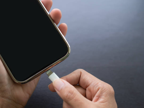 istock Finger holding cable USB type C for charge battery mobile smartphone. 1405535960
